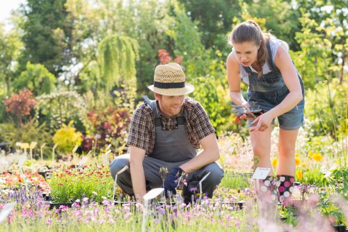 Landscaper wearing safety gear during garden maintenance and waste removal
